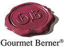 Logo des Feinkostunternehmens Gourmet Berner: ein dunkelrotes Wachssiegel mit den Initialen GB.